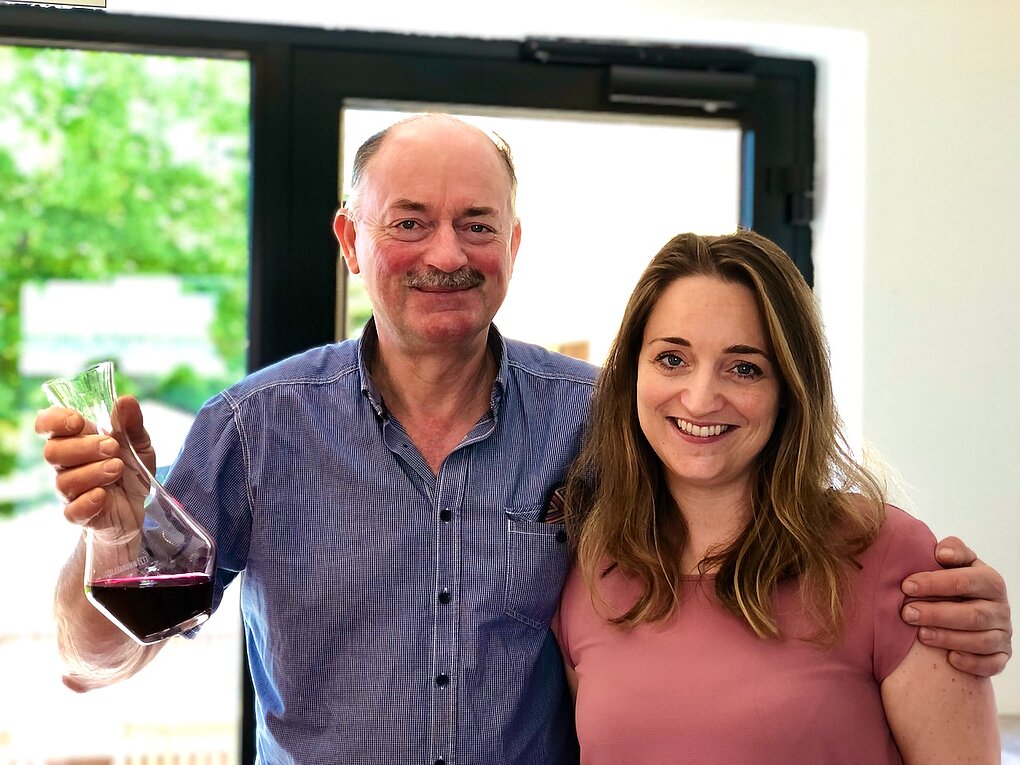 Carnuntum winemakers Franz and Christina Netzl holding a decanter of Rubin Carnuntum wine