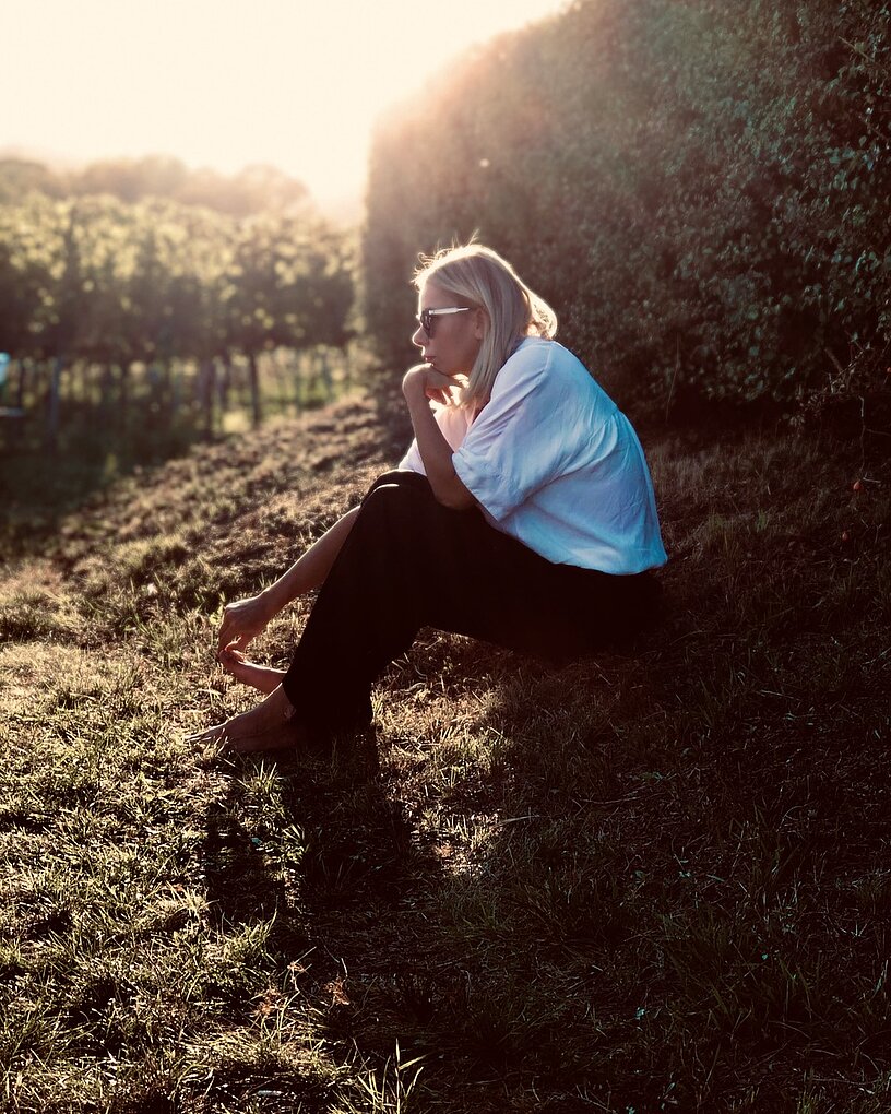 Carnuntum winemaker Karoline Taferner sitting in an Austrian vineyard.