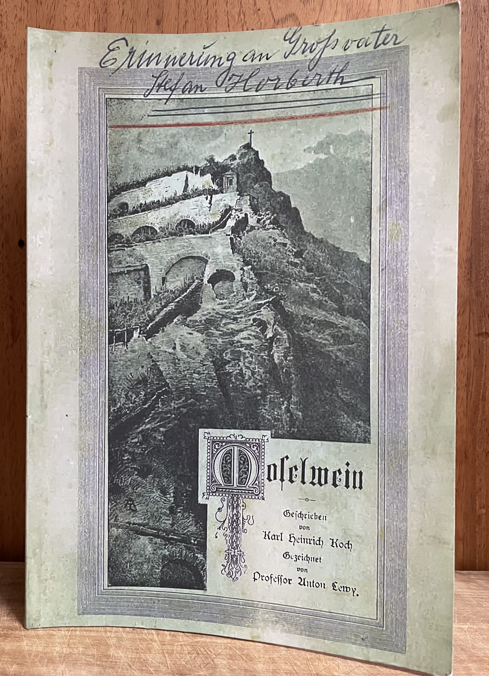 Close up of Moselwein book with green cover on a wooden table