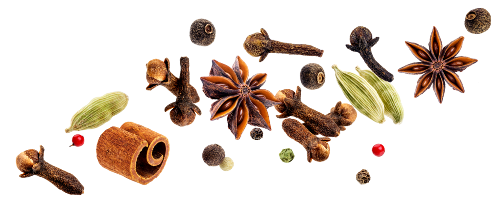 Whole spices scattered across a transparent background.