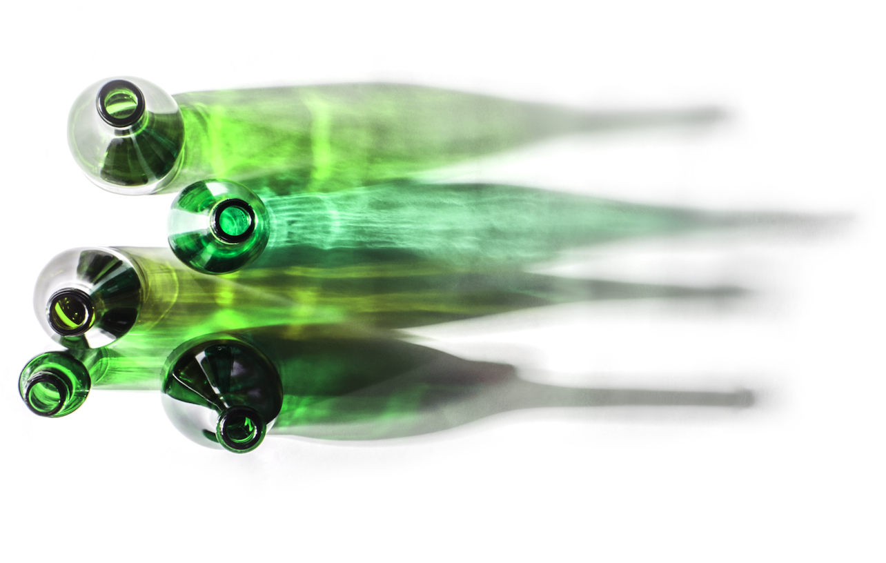 top view of 5 green wine bottles and their shadows on a white table