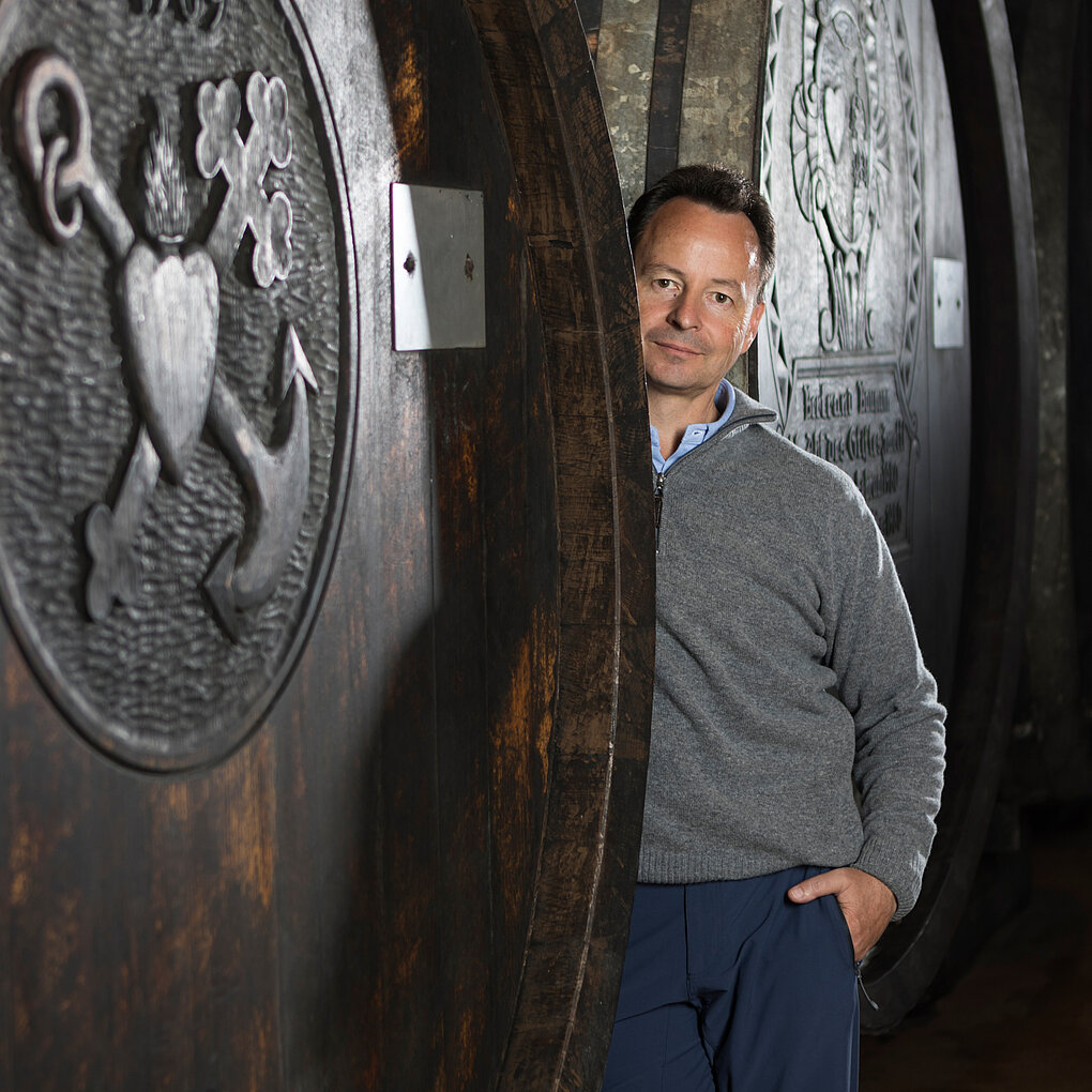 Austrian winemaker Michael Moosbrugger leans against wine casks in his Schloss Gobelsburg estate.