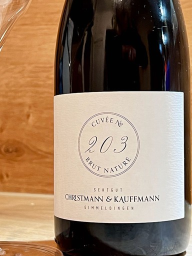 Black wine bottle with white label and lettering reading Cuvee No. 203 Brut Nature, Sektgut Christmann / Kauffmann