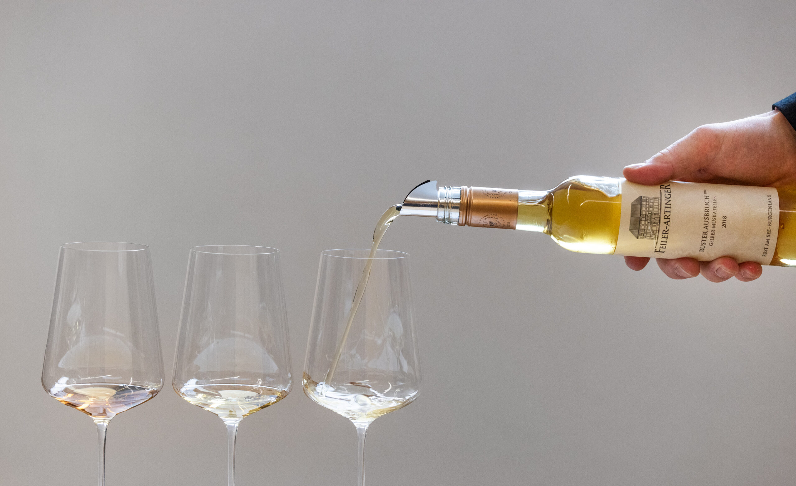 Pouring Austrian fine wine into three glasses