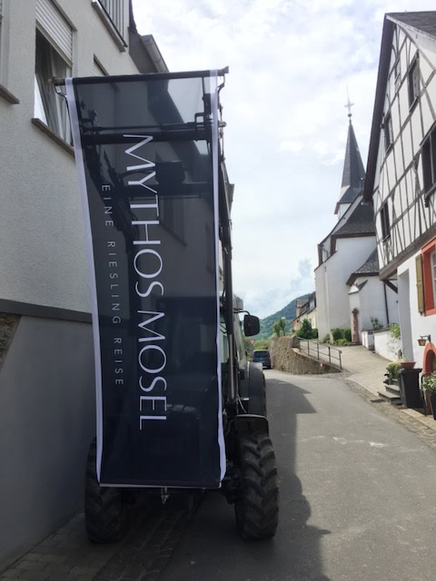 Mythos Mosel flag hanging off a tractor in Germany's Mosel valley.