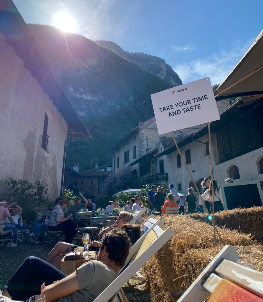 Summa guests lounge in the late-afternoon sun outdoors.