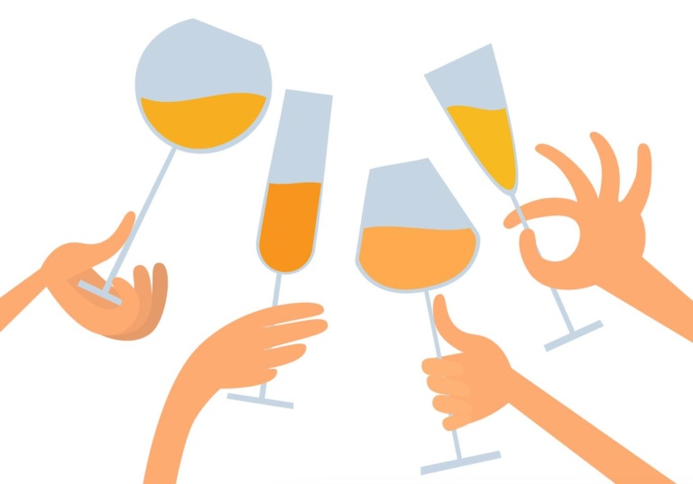 A group of hands holding glasses of orange wine