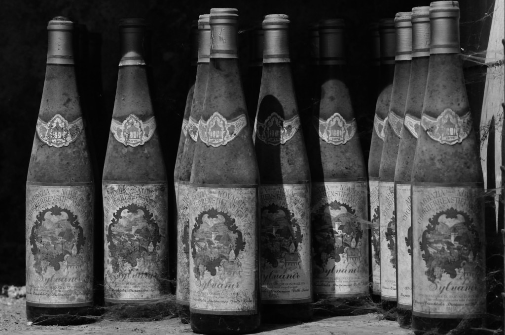 A black and white photo of bottles of wine.