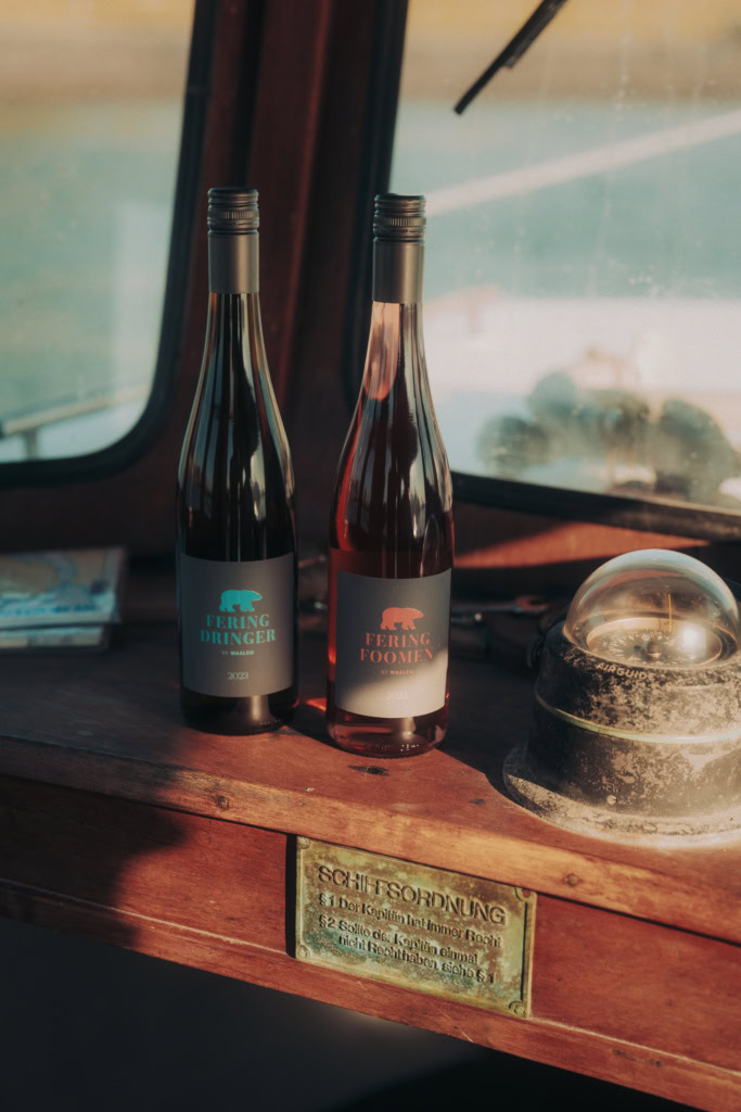 Two wine bottles on the captain's lookout on a ship.