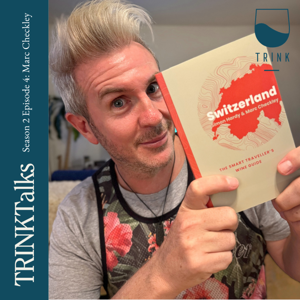 Swiss wine expert Marc Checkley holds a book.